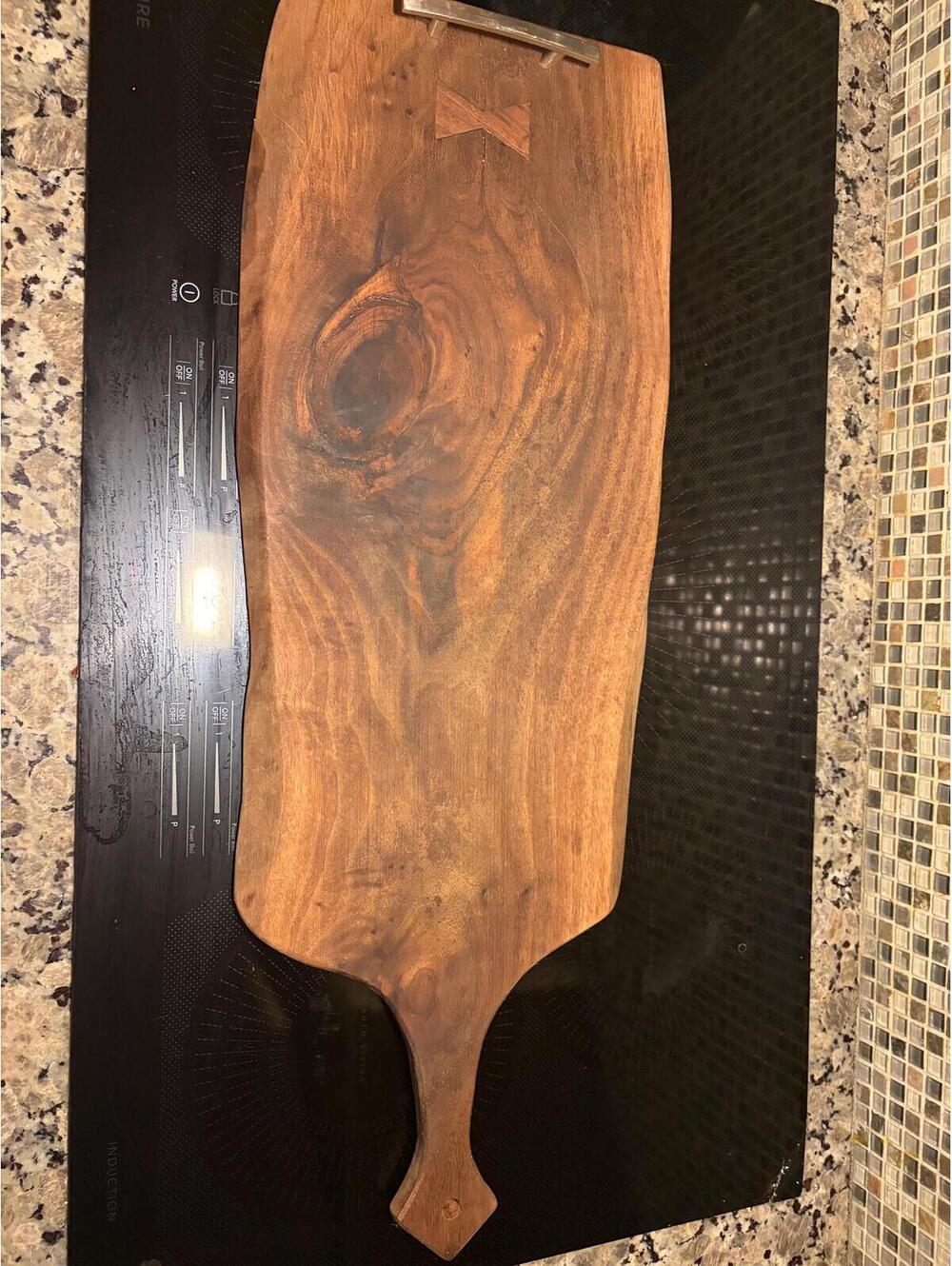 This is a vintage handmade live-edge walnut wooden charcuterie and serving board
